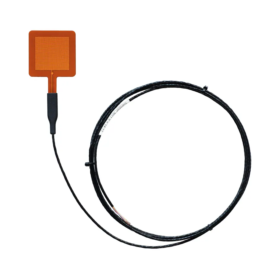 A FHF05SC Self-Calibrating Foil Heat Flux Sensor with the cord attached.