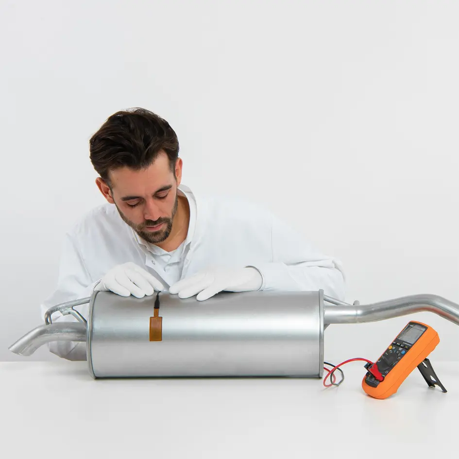 A man applying a FHF06 Heat Flux Sensor to a canister.