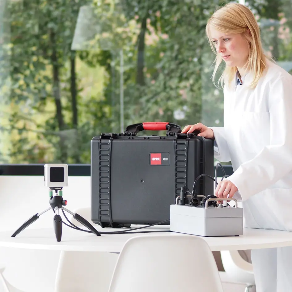 A woman using a TCOMSYS01 Hot Cube with the case next to it.